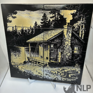 LASER ENGRAVE CABIN WITH FIREWOOD ON LAKE PROCESSED ON PAINTED TILE MOUNTED TO PINE BOARD FOR BACKING INCLUDES STAIN FRAME & STAND 12x12